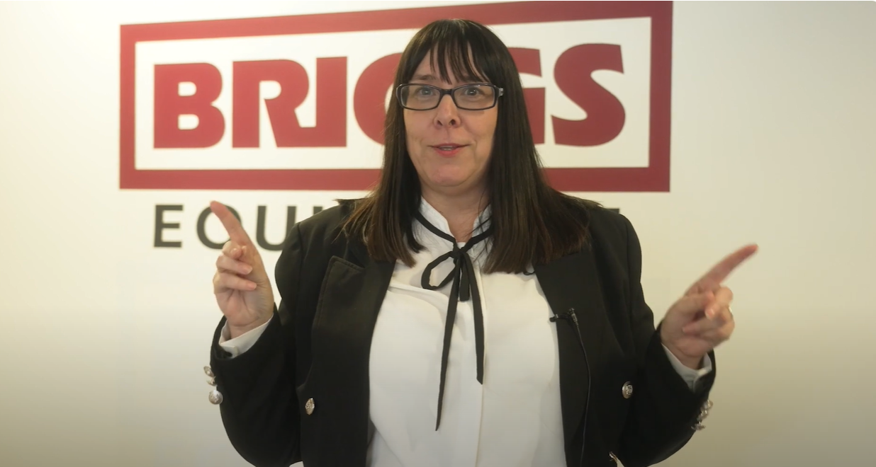 Briggs Equipment Member of Staff Pointing At The Briggs Sign