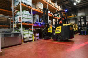 A Combilift AisleMaster forklift stacking shelves in the warehouse