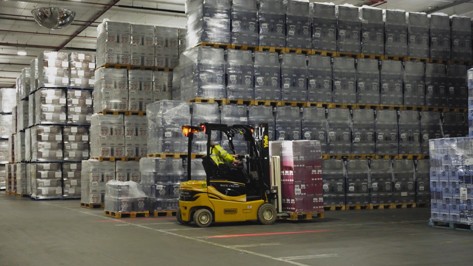 A Yale electric counterbalance forklift stacking pallets at the Whyte & Mackay warehouse.