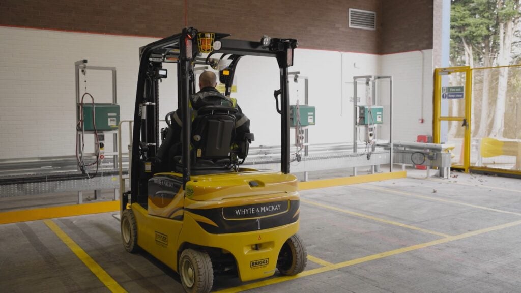 An electric forklift being fueled at a charging station. There are multiple fuel types to power your machinery. Picking the right one can be vital for efficiency, task completion or even contributing to your business' ESG goals.