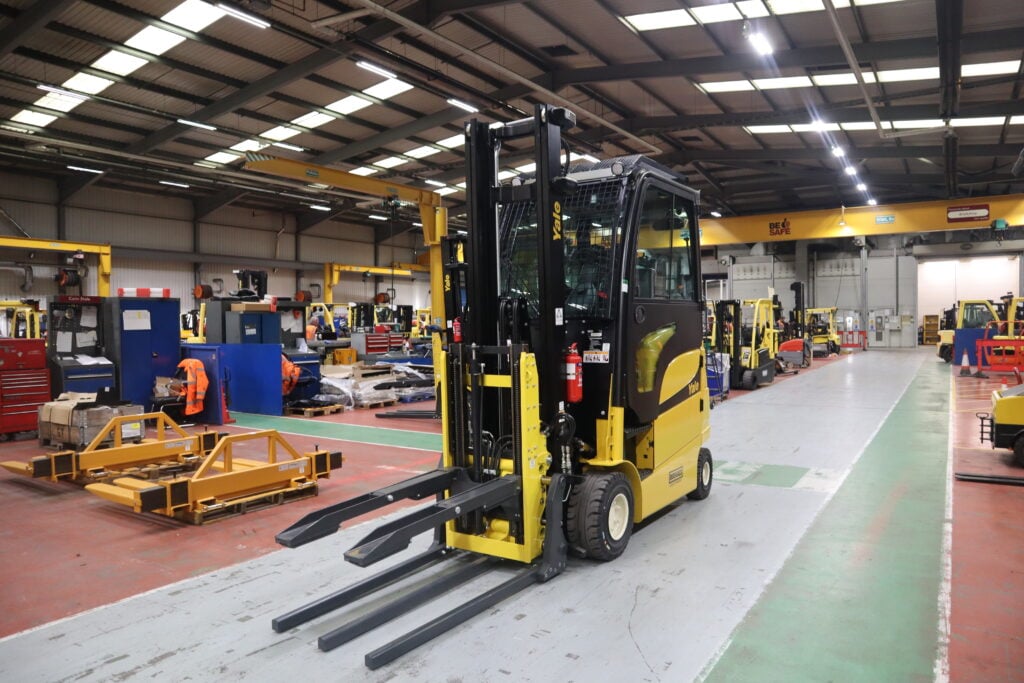 A Yale forklift equipped with a keg clamp forklift attachment.