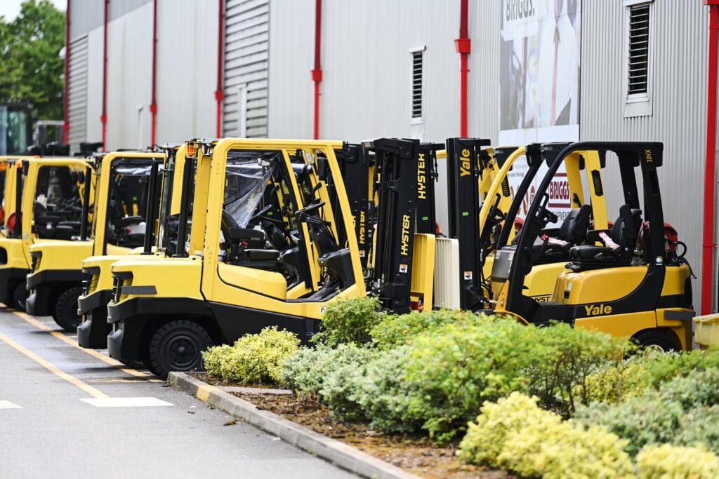 Hyster and Yale forklifts parked in rows outside